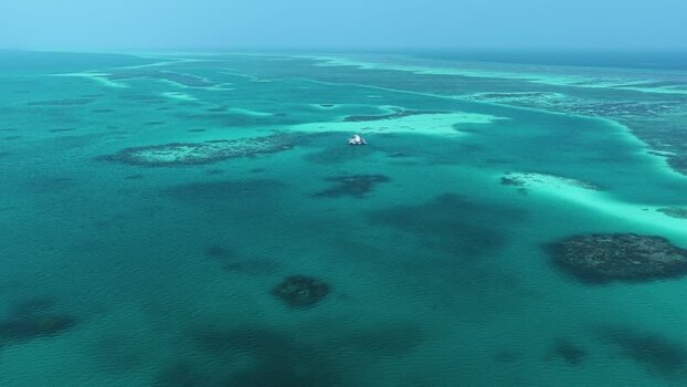 Aerial view of a boat in turquoise waters Maldives. Aerial view of a boat in turquoise waters Maldives.