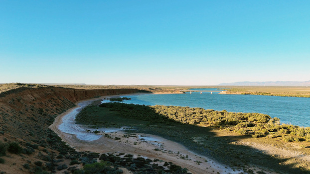 Aerial view of Matthew Flinders Red Cliff Lookout with its distinctive red cliffs coastal vegetation and the bridge spanning the water in Port Augusta West South Australia Australia. Aerial view of Matthew Flinders Red Cliff Lookout with its distinctive red cliffs coastal vegetation and the bridge spanning the water in Port Augusta West South Australia Australia.