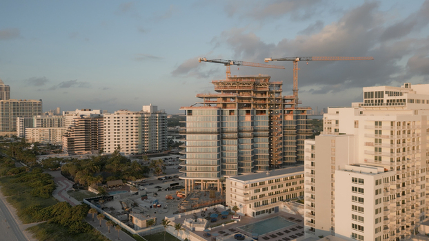 Aerial view of a high rise building under construction with cranes in the coastal city of Miami Beach Florida United States. Aerial view of a high rise building under construction with cranes in the coastal city of Miami Beach Florida United States.