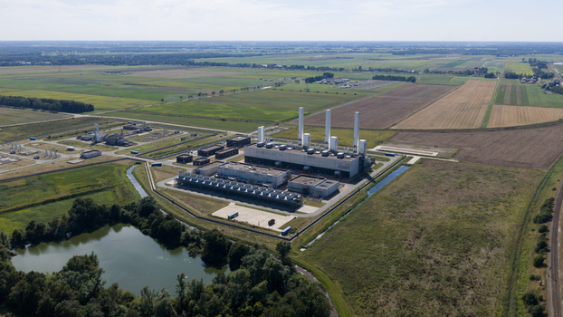 Aerial view of the GasunieAir Products nitrogen factory with industrial buildings tall chimneys and cooling units surrounded by fields and a pond in Muntendam Groningen Netherlands.
