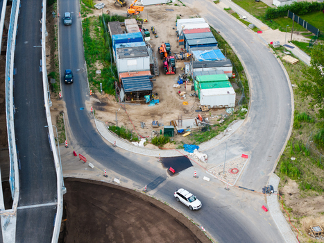 Riga Latvia 04 July 2026 Aerial view of the Janis Cakste Avenue construction site featuring heavy machinery shipping containers and road works near the Southern Bridge project. Riga Latvia 04 July 2026 Aerial view of the Janis Cakste Avenue construction site featuring heavy machinery shipping containers and road works near the Southern Bridge project.