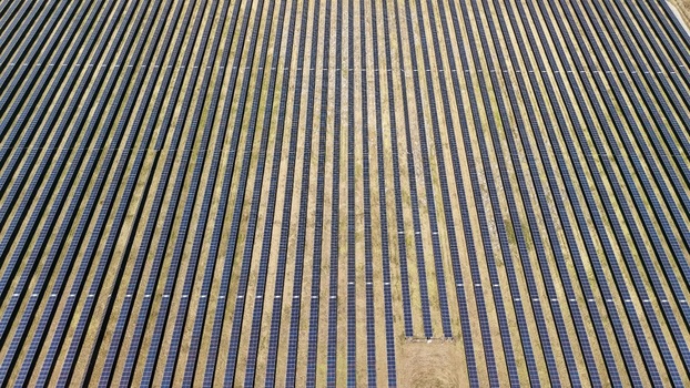 Aerial view of solar panels stretching across the landscape a sea of dark rectangles contrasting with the pale earth Elkton Florida United States. Aerial view of solar panels stretching across the landscape a sea of dark rectangles contrasting with the pale earth Elkton Florida United States.