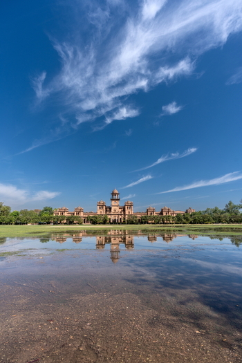 View of Islamia College University Peshawar with its historic architecture reflected in a pool of water under a clear blue sky in Peshawar Khyber Pakhtunkhwa Pakistan. View of Islamia College University Peshawar with its historic architecture reflected in a pool of water under a clear blue sky in Peshawar Khyber Pakhtunkhwa Pakistan.