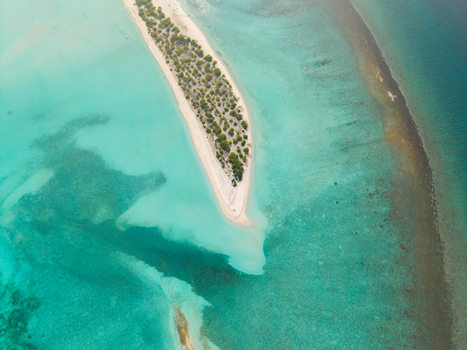 Aerial view of the serene Kan island embraced by turquoise waters a tranquil escape in the Maldives Dhidhdhoo Thiladhunmathi Atoll Maldives.