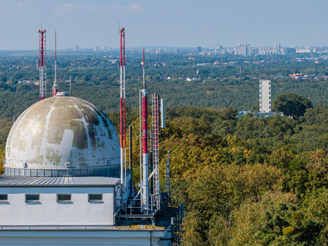 Aerial view of Archenhold Sternwarte with its dome and communication towers overlooking the Treptower Park forest with the distant Muggelturm in Berlin Berlin Germany. Aerial view of Archenhold Sternwarte with its dome and communication towers overlooking the Treptower Park forest with the distant Muggelturm in Berlin Berlin Germany.