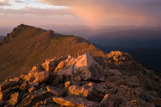 Aerial view of Notch Mountain Shelter Mount of the Holy Cross in the Sawatch Range of the Rocky Mountains illuminated by sunset golden hour light with rocky terrain in Vail Colorado USA. Aerial view of Notch Mountain Shelter Mount of the Holy Cross in the Sawatch Range of the Rocky Mountains illuminated by sunset golden hour light with rocky terrain in Vail Colorado USA.