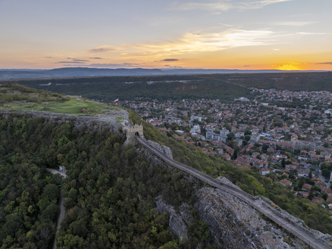 Aerial view of the historic Ovech Fortress perched on a rocky plateau overlooking the town of Provadia with lush forests and a sunset sky Provadia Varna Bulgaria. Aerial view of the historic Ovech Fortress perched on a rocky plateau overlooking the town of Provadia with lush forests and a sunset sky Provadia Varna Bulgaria.