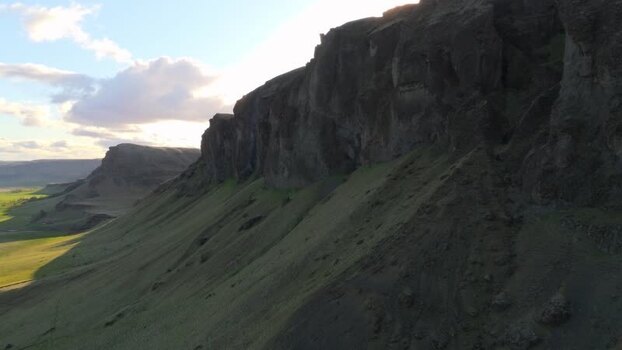 Aerial view of steep rocky cliffs and green slopes Iceland. Aerial view of steep rocky cliffs and green slopes Iceland.