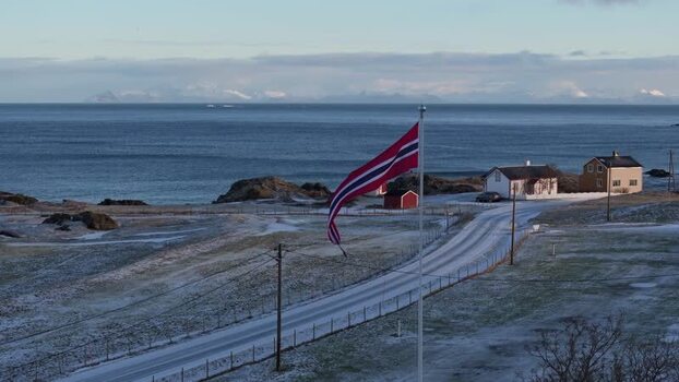 Aerial view of Lofoten coastline with Norwegian flag Norway.