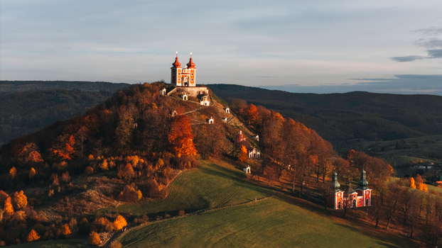 Aerial view of Kalvaria Banska Stiavnica with its red baroque chapels on a hill surrounded by vibrant autumn trees Banska Stiavnica Banskobystricky kraj Slovakia.