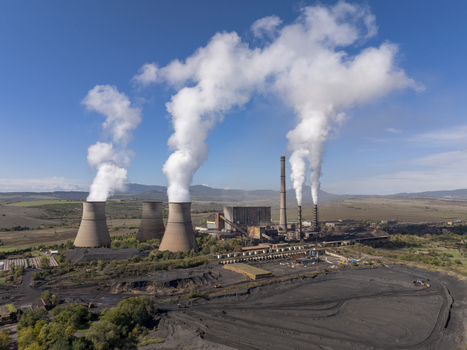 Aerial view of Bobov Dol Power Plant with cooling towers emitting thick white smoke against a clear blue sky in a rural landscape in Golemo Selo Kyustendil Province Bulgaria. Aerial view of Bobov Dol Power Plant with cooling towers emitting thick white smoke against a clear blue sky in a rural landscape in Golemo Selo Kyustendil Province Bulgaria.