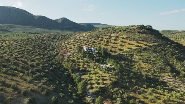 Aerial view of a white villa on a hillside in El Tarajal Spain.