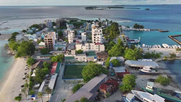 Aerial view of the island town of Gulhi with its harbor and beach Maldives. Aerial view of the island town of Gulhi with its harbor and beach Maldives.