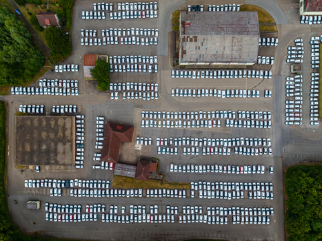 Aerial view of Serways Raststatte Hohenlohe Sud with rows of parked white cars in a large parking lot surrounded by trees and asphalt in Neuenstein Baden Wurttemberg Germany. Aerial view of Serways Raststatte Hohenlohe Sud with rows of parked white cars in a large parking lot surrounded by trees and asphalt in Neuenstein Baden Wurttemberg Germany.