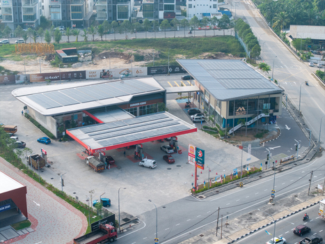 Bukit Tambun Penang Malaysia 25 September 2026 Aerial view of a Caltex gas station and commercial building with rooftop solar panels in an urban setting with nearby roads and vehicles.