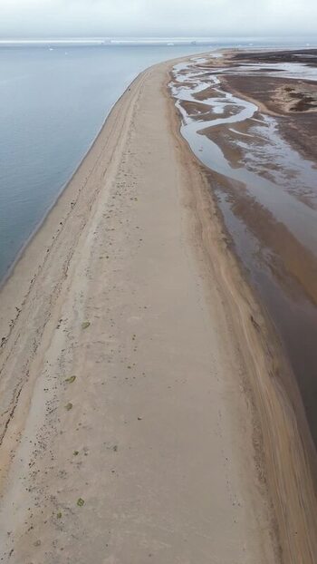 Aerial view of a long sandy beach and coastal wetlands Greenland. Aerial view of a long sandy beach and coastal wetlands Greenland.