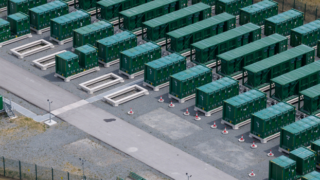 Aerial view of the Thurrock Flexible Generation Substation featuring rows of green battery energy storage containers on a gravel site in Tilbury England United Kingdom.