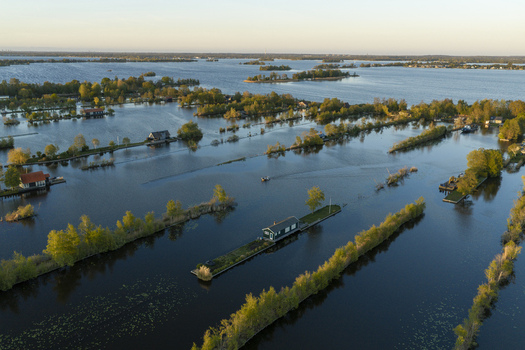 Aerial view of Scheendijk featuring small islands with houses surrounded by water and lush greenery in Breukelen Utrecht Netherlands. Aerial view of Scheendijk featuring small islands with houses surrounded by water and lush greenery in Breukelen Utrecht Netherlands.