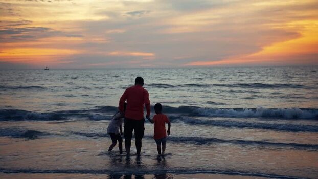 View of a father and children at sunset in Cox s Bazar Bangladesh.
