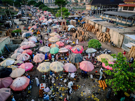 Aerial view of the bustling Panteka Market with colorful umbrellas and people among various stalls Kaduna Kaduna Nigeria. Aerial view of the bustling Panteka Market with colorful umbrellas and people among various stalls Kaduna Kaduna Nigeria.