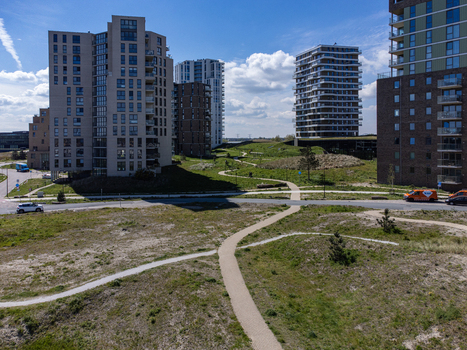 Aerial view of modern buildings contrasting with sandy dunes and winding pathways Duinvalleiweg Almere Flevoland Netherlands.