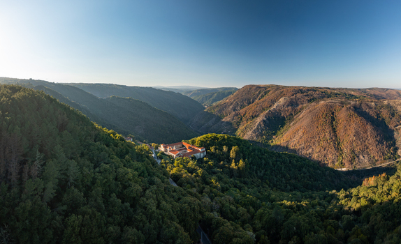 Aerial view of the Monastery of Santo Estevo de Ribas de Sil nestled within the lush green forests of the Ribeira Sacra valley in O Covelo Ourense Spain.