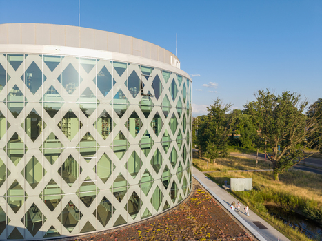 Diepenbeek Belgium 01 July 2026 Aerial view of the University College Leuven Limburg campus building with a circular glass facade diamond patterned grid and surrounding greenery. Diepenbeek Belgium 01 July 2026 Aerial view of the University College Leuven Limburg campus building with a circular glass facade diamond patterned grid and surrounding greenery.