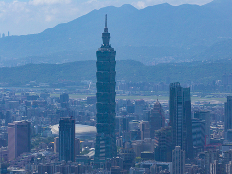 Aerial view of Taipei 101 skyscraper rising above the dense urban skyline of Taipei City Taiwan. Aerial view of Taipei 101 skyscraper rising above the dense urban skyline of Taipei City Taiwan.