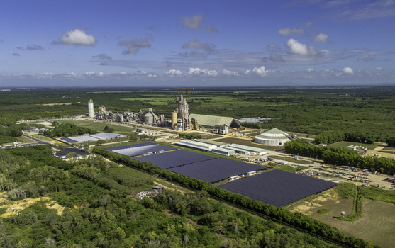 Aerial view of the Cemento Panam industrial facility with a large solar panel array and manufacturing buildings set in the green landscape of Los Llanos San Pedro de Macoris Dominican Republic. Aerial view of the Cemento Panam industrial facility with a large solar panel array and manufacturing buildings set in the green landscape of Los Llanos San Pedro de Macoris Dominican Republic.