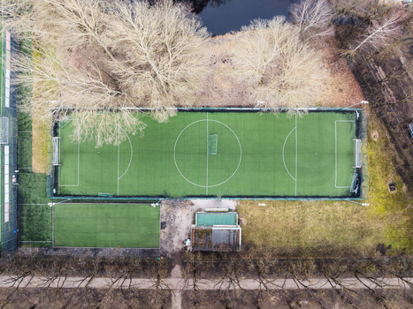 Aerial view of Arkadijas sporta un atputas parks a soccer field surrounded by bare trees in early spring in Riga Latvia. Aerial view of Arkadijas sporta un atputas parks a soccer field surrounded by bare trees in early spring in Riga Latvia.