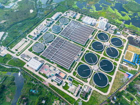 Aerial view of Sewage Treatment Plant Dhaka WASA with circular clarifiers and rectangular aeration tanks surrounded by greenery in Dhaka Dhaka Division Bangladesh. Aerial view of Sewage Treatment Plant Dhaka WASA with circular clarifiers and rectangular aeration tanks surrounded by greenery in Dhaka Dhaka Division Bangladesh.