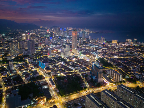 George Town Penang Malaysia 22 September 2026 Aerial view of the illuminated George Town cityscape at night featuring dense urban architecture glowing street lights and high rise buildings.