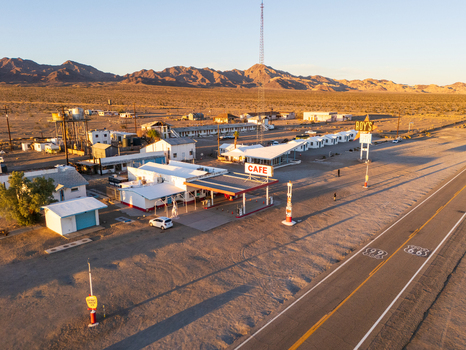Amboy United States 06 April 2026 Aerial view of Amboy s desolate charm where the iconic Roy s Motel and Cafe basks in the sun s golden embrace a stark contrast to the arid desert landscape. Amboy United States 06 April 2026 Aerial view of Amboy s desolate charm where the iconic Roy s Motel and Cafe basks in the sun s golden embrace a stark contrast to the arid desert landscape.