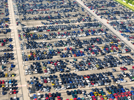 Aerial view of a massive car storage lot with thousands of vehicles parked in organized rows at a logistics hub in Rivalta di Torino Piedmont Italy. Aerial view of a massive car storage lot with thousands of vehicles parked in organized rows at a logistics hub in Rivalta di Torino Piedmont Italy.