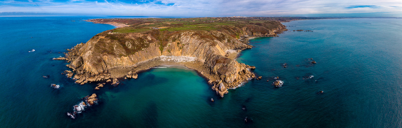 Aerial view of the dramatic rugged cliffs of Nez de Jobourg overlooking the turquoise waters of the English Channel in La Hague Normandie France. Aerial view of the dramatic rugged cliffs of Nez de Jobourg overlooking the turquoise waters of the English Channel in La Hague Normandie France.