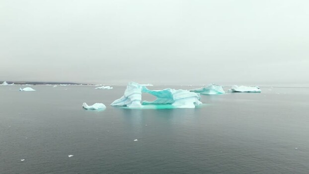 Aerial view of icebergs floating in the Arctic sea Greenland. Aerial view of icebergs floating in the Arctic sea Greenland.
