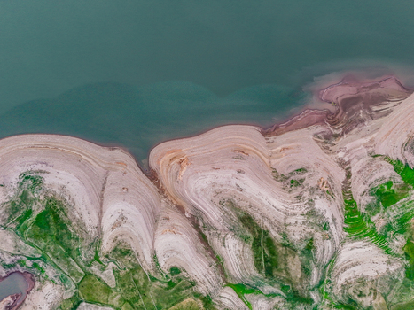 Aerial view of the stark contrast between the turquoise water and the terraced earthy shoreline Chakswari Azad Kashmir Pakistan. Aerial view of the stark contrast between the turquoise water and the terraced earthy shoreline Chakswari Azad Kashmir Pakistan.