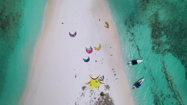 Aerial view of Los Roques sandbar with kitesurfing kites Venezuela.