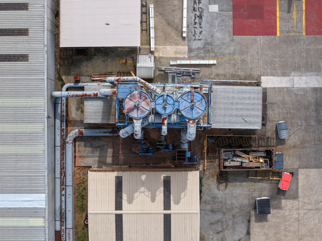 Aerial view of industrial machinery and pipes situated within a factory complex in Melbourne VIC Australia.