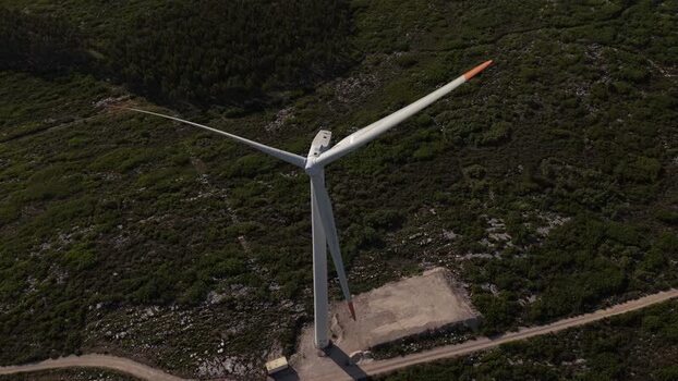 Aerial view of a wind turbine on a green hillside Portugal. Aerial view of a wind turbine on a green hillside Portugal.
