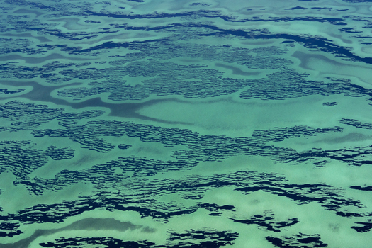 Aerial view of intricate turquoise and deep blue ocean patterns of the shallow waters and sandbanks of Shark Bay Shire of Shark Bay Western Australia Australia. Aerial view of intricate turquoise and deep blue ocean patterns of the shallow waters and sandbanks of Shark Bay Shire of Shark Bay Western Australia Australia.