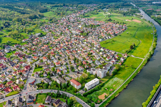 Aerial view of the Buckenhofen district with residential houses lush green meadows and the Main Donau Kanal river in Forchheim Bayern Germany. Aerial view of the Buckenhofen district with residential houses lush green meadows and the Main Donau Kanal river in Forchheim Bayern Germany.