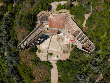 Aerial view of the Monument of the Bulgarian Soviet Friendship with its brutalist concrete architecture and weathered roof surrounded by lush forest in Varna Varna Bulgaria.