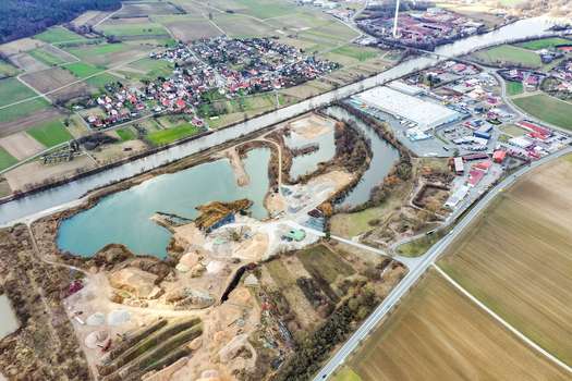 Aerial view of the town of Buttenheim showing the industrial district the Regnitz river and vast agricultural landscapes Buttenheim Bavaria Germany. Aerial view of the town of Buttenheim showing the industrial district the Regnitz river and vast agricultural landscapes Buttenheim Bavaria Germany.