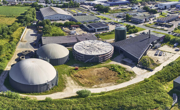 Schleswig Germany 26 June 2026 Aerial view of biogas works on industrial site with large storage tanks green fields and surrounding industrial buildings. Schleswig Germany 26 June 2026 Aerial view of biogas works on industrial site with large storage tanks green fields and surrounding industrial buildings.