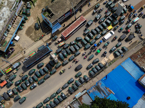 Rajshahi Bangladesh 26 September 2026 Aerial view of a busy street filled with numerous auto rickshaws and a bus showcasing urban traffic in the city. Rajshahi Bangladesh 26 September 2026 Aerial view of a busy street filled with numerous auto rickshaws and a bus showcasing urban traffic in the city.