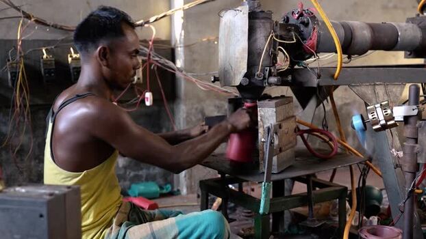 View of a man operating industrial machinery in Bogura Bangladesh. View of a man operating industrial machinery in Bogura Bangladesh.