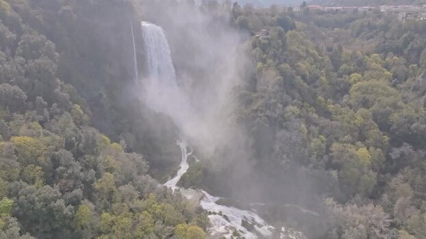 Aerial view of Marmore Falls cascading through lush forests Italy.