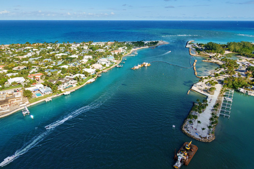 Aerial view of where the Loxahatchee River meets the sea a symphony of blues and greens contrasting with the sandy shores Jupiter Florida United States.