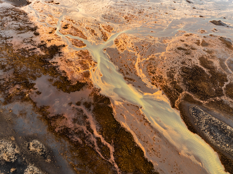 Aerial view of a braided glacial river flowing through volcanic sediment in Iceland. Aerial view of a braided glacial river flowing through volcanic sediment in Iceland.